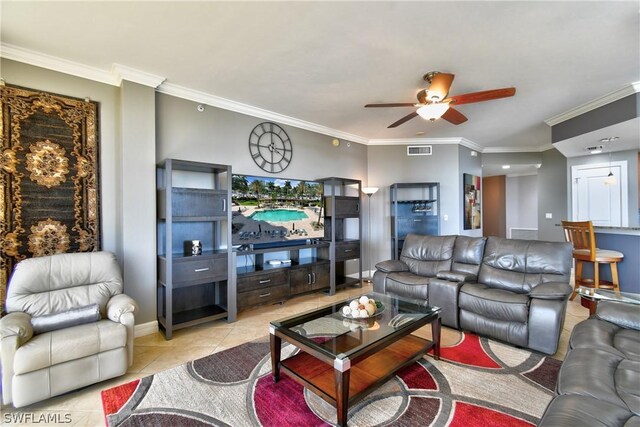 living room featuring ceiling fan, light tile patterned floors, and ornamental molding