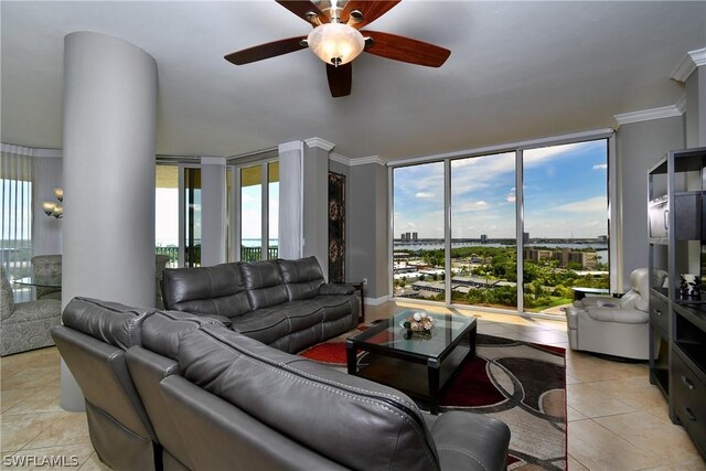 living room featuring ceiling fan, plenty of natural light, light tile patterned flooring, and ornamental molding