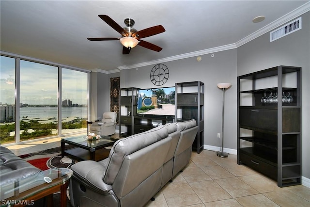 living room featuring visible vents, baseboards, ceiling fan, ornamental molding, and light tile patterned floors