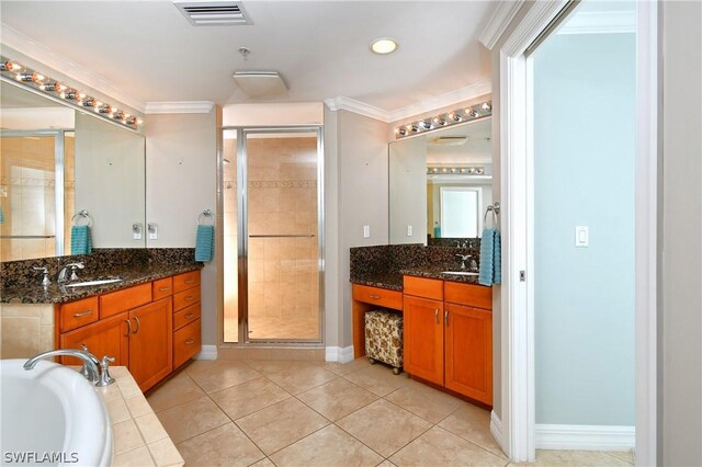 bathroom with tile patterned flooring, vanity, ornamental molding, and independent shower and bath