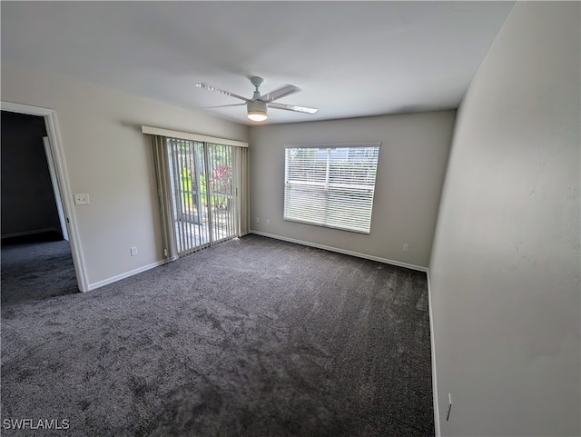 carpeted spare room featuring ceiling fan