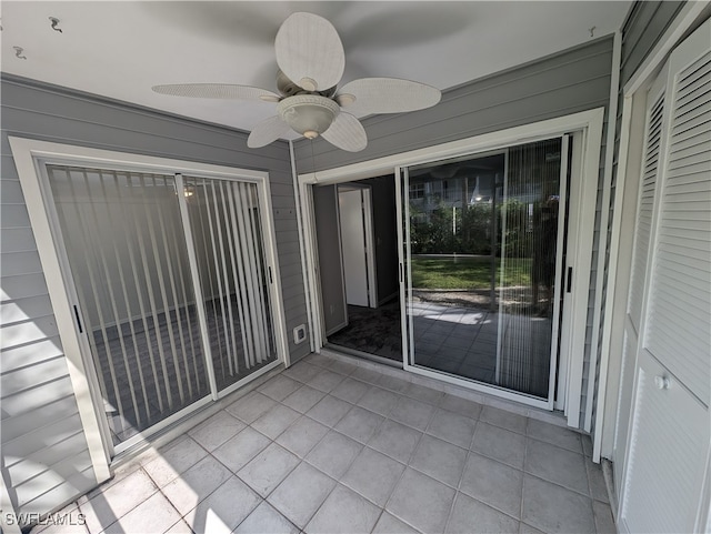 unfurnished sunroom featuring ceiling fan