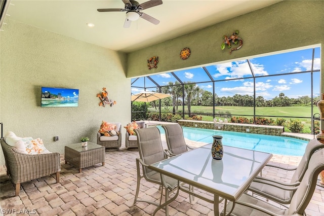 view of patio / terrace featuring an outdoor living space, ceiling fan, and a lanai