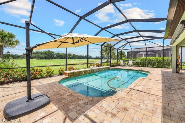 view of swimming pool with glass enclosure and a patio area