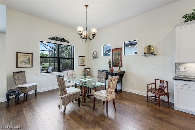 dining area with a chandelier and dark wood-type flooring