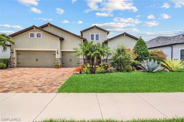 view of front of home with a garage and a front yard