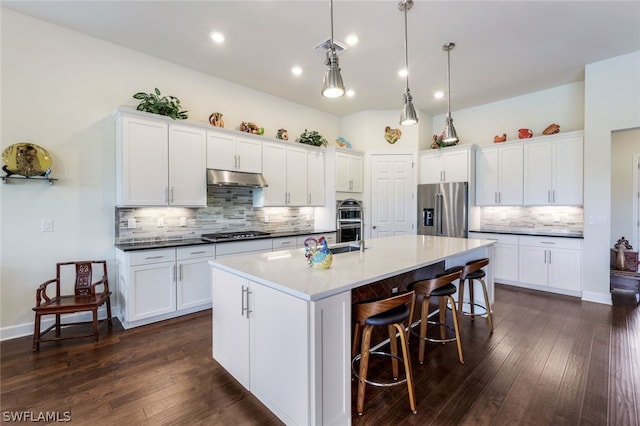 kitchen featuring white cabinetry, pendant lighting, stainless steel appliances, and dark hardwood / wood-style floors