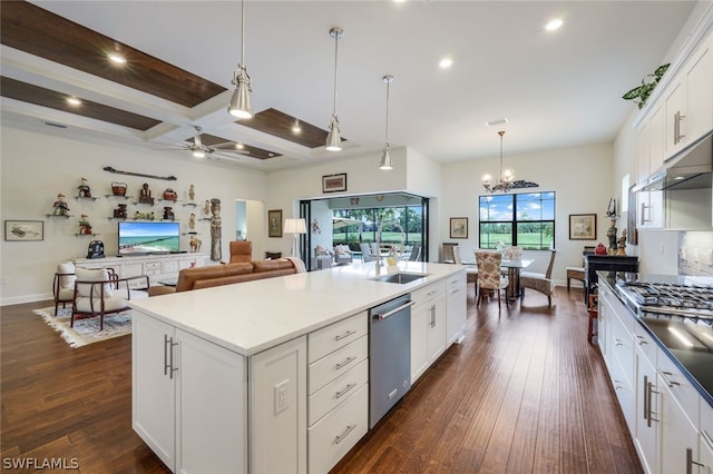 kitchen with dark hardwood / wood-style flooring, stainless steel appliances, a kitchen island with sink, decorative light fixtures, and white cabinets