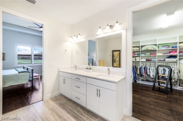 bathroom featuring hardwood / wood-style flooring, vanity, and ceiling fan