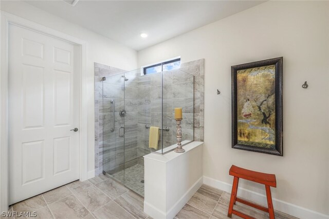 bathroom featuring a shower with shower door