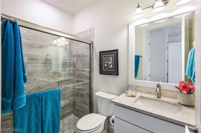 bathroom with vanity, toilet, and walk in shower