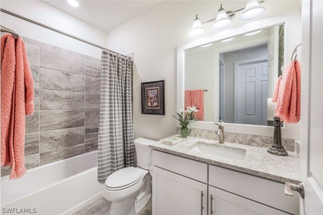 full bathroom featuring vanity, shower / bath combination with curtain, and toilet