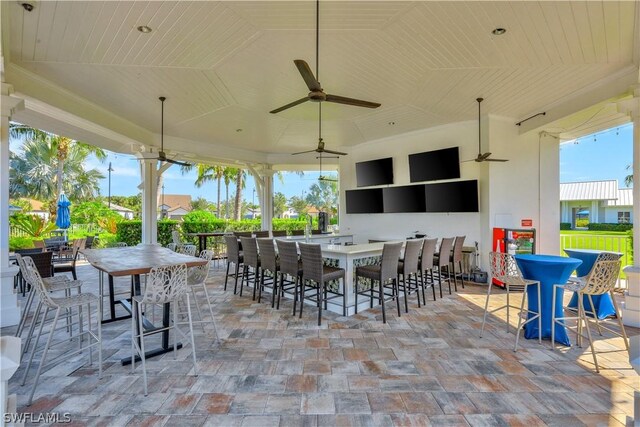 view of patio with an outdoor bar and ceiling fan