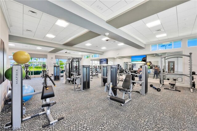 exercise room featuring a drop ceiling and ornamental molding