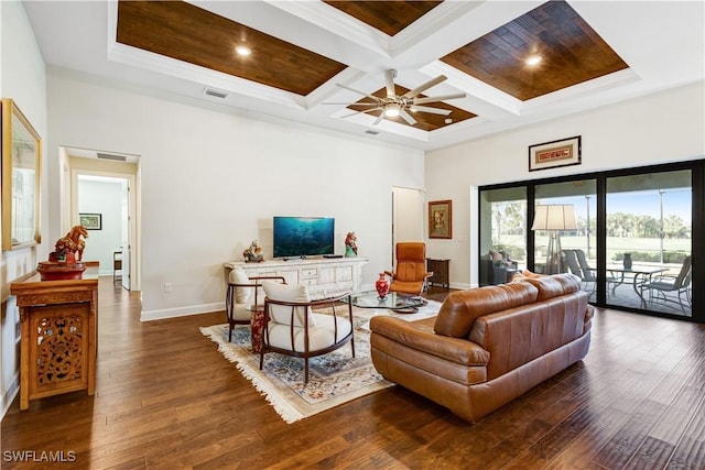 living room featuring beam ceiling, a high ceiling, coffered ceiling, crown molding, and dark hardwood / wood-style floors