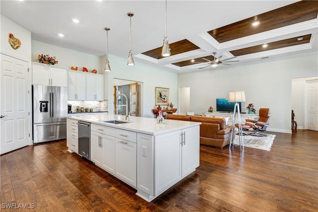 kitchen with a center island with sink, high end refrigerator, coffered ceiling, white cabinets, and pendant lighting