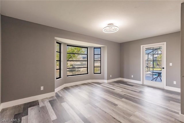 spare room with light hardwood / wood-style flooring