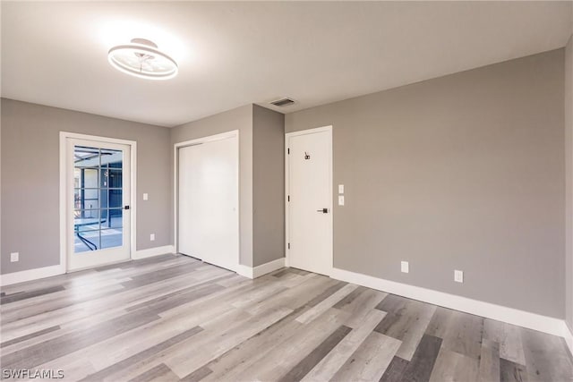 unfurnished room featuring light hardwood / wood-style floors