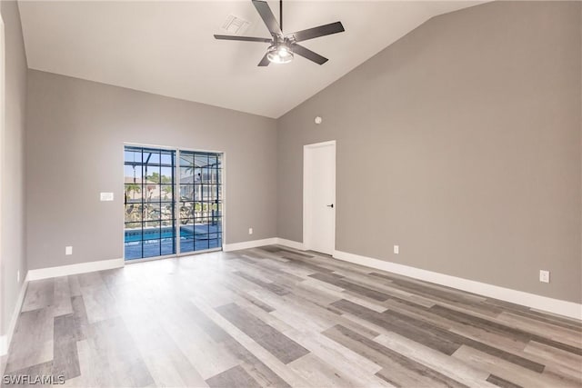 spare room with ceiling fan, light hardwood / wood-style floors, and high vaulted ceiling