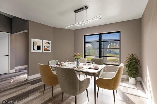 dining space featuring wood-type flooring