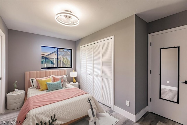 bedroom with a closet and dark hardwood / wood-style floors