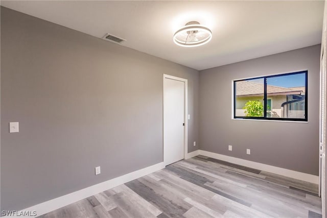 spare room featuring light hardwood / wood-style floors