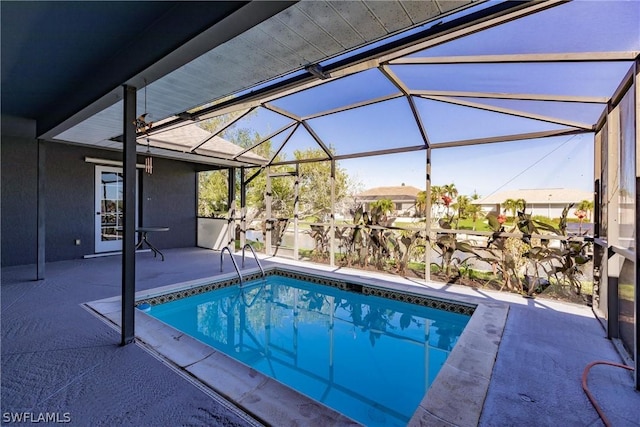 view of swimming pool with a patio area and glass enclosure