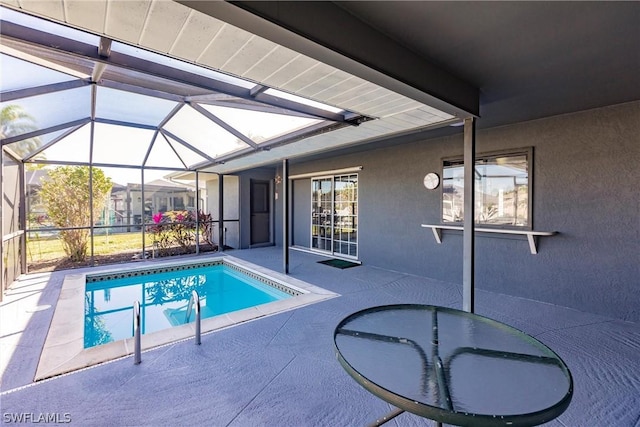 view of pool with a lanai and a patio