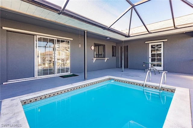 view of pool with a lanai and a patio