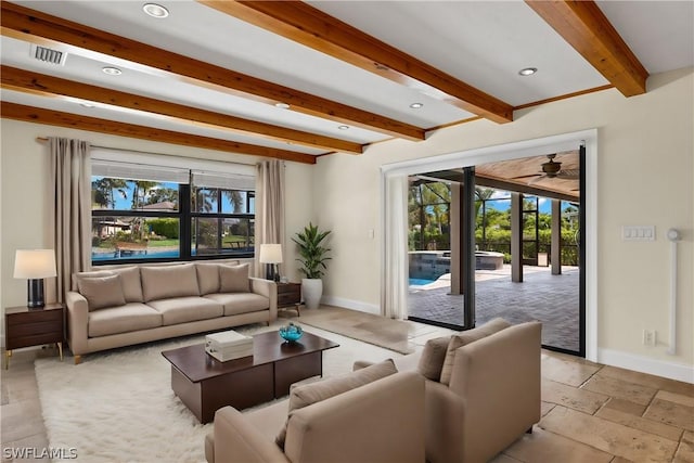 living room featuring beam ceiling, ceiling fan, and a healthy amount of sunlight