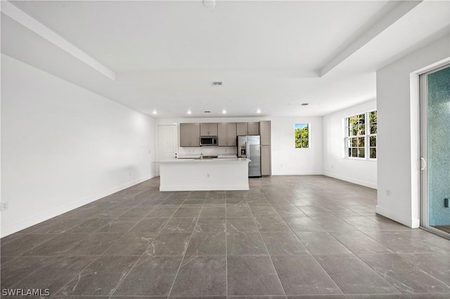 unfurnished living room with a tray ceiling