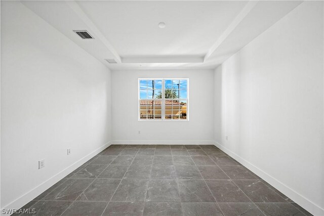 empty room with a raised ceiling