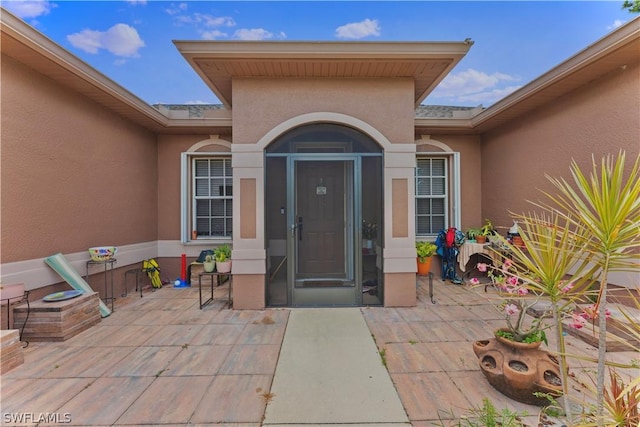 property entrance with a patio area