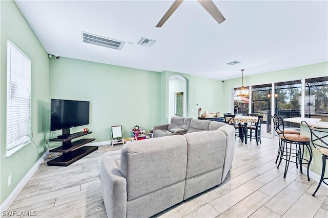 living room with light hardwood / wood-style floors and ceiling fan