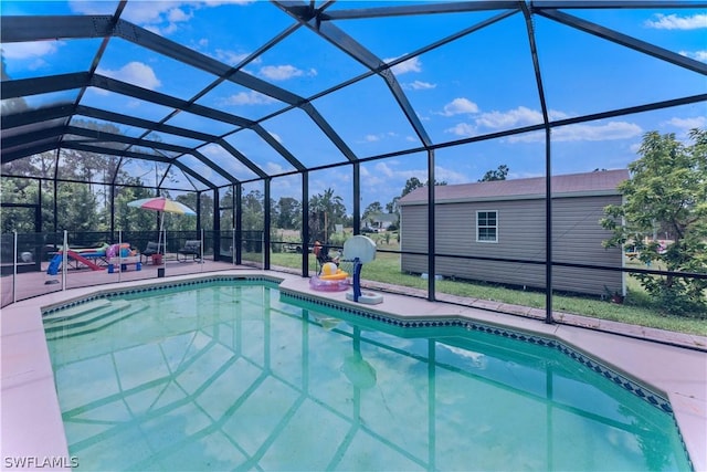 view of swimming pool featuring a lanai and a patio