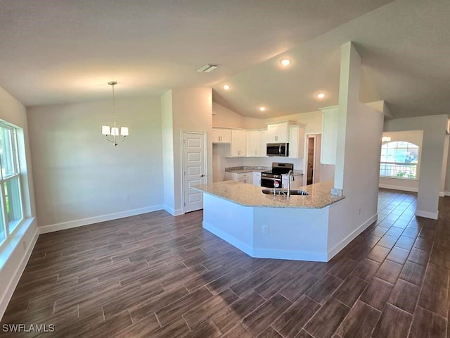 kitchen with stainless steel appliances, vaulted ceiling, white cabinets, light stone counters, and dark hardwood / wood-style flooring