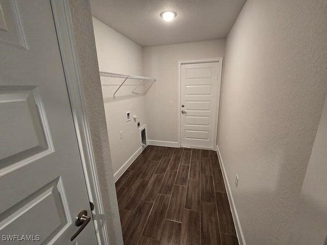 clothes washing area featuring hookup for an electric dryer, washer hookup, a textured ceiling, and dark wood-type flooring