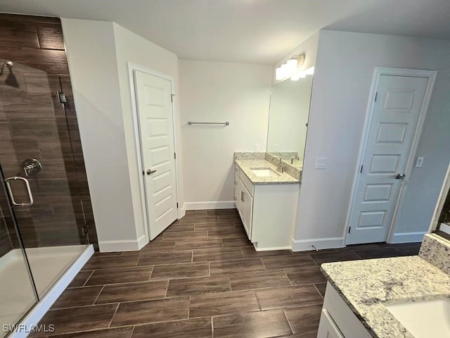 bathroom featuring vanity and a shower with shower door