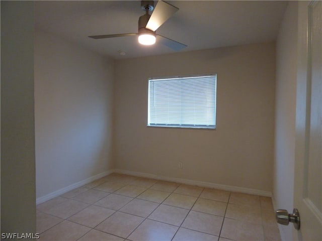 spare room featuring ceiling fan and light tile floors