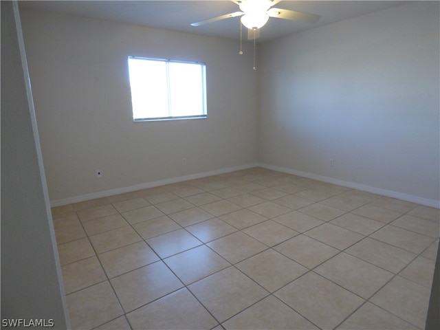 tiled empty room with ceiling fan