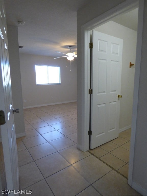 hall featuring light tile flooring