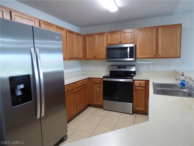 kitchen featuring sink, light tile floors, and appliances with stainless steel finishes