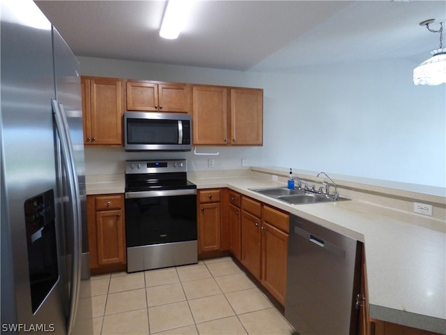 kitchen featuring stainless steel appliances, sink, light tile floors, and pendant lighting