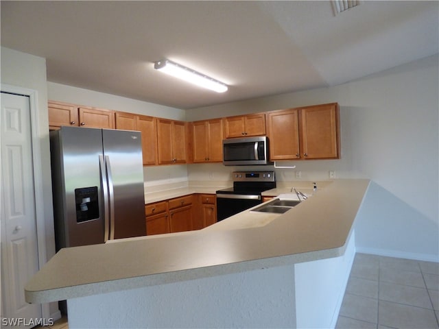 kitchen with sink, light tile flooring, kitchen peninsula, and stainless steel appliances