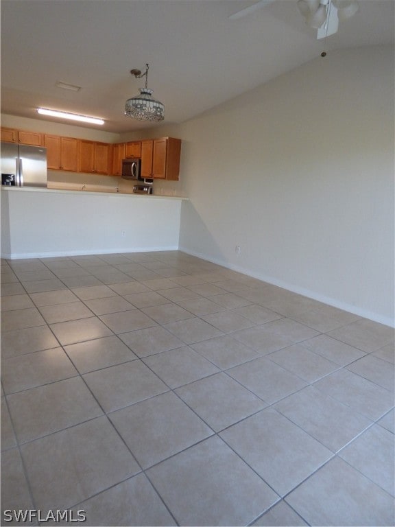 unfurnished living room featuring light tile flooring and ceiling fan