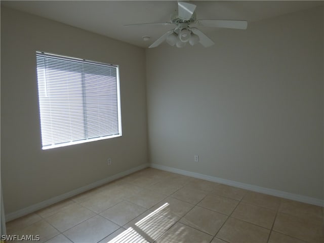 empty room with ceiling fan and light tile floors