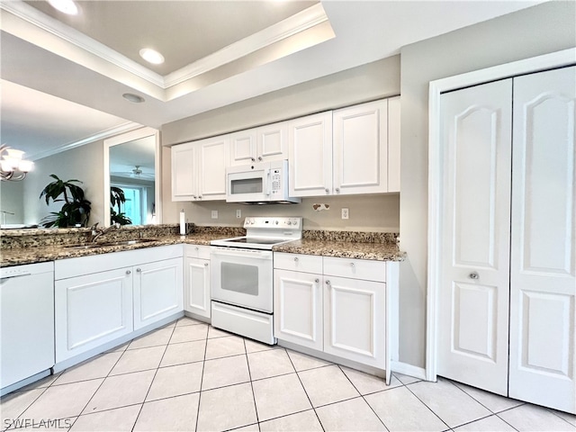 kitchen with white cabinetry, ornamental molding, white appliances, sink, and a raised ceiling