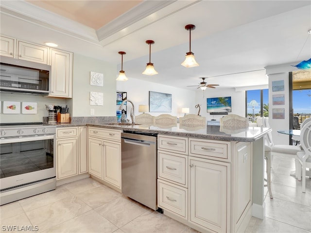 kitchen featuring ceiling fan, kitchen peninsula, sink, and appliances with stainless steel finishes