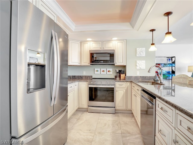 kitchen with light stone countertops, appliances with stainless steel finishes, a tray ceiling, sink, and hanging light fixtures