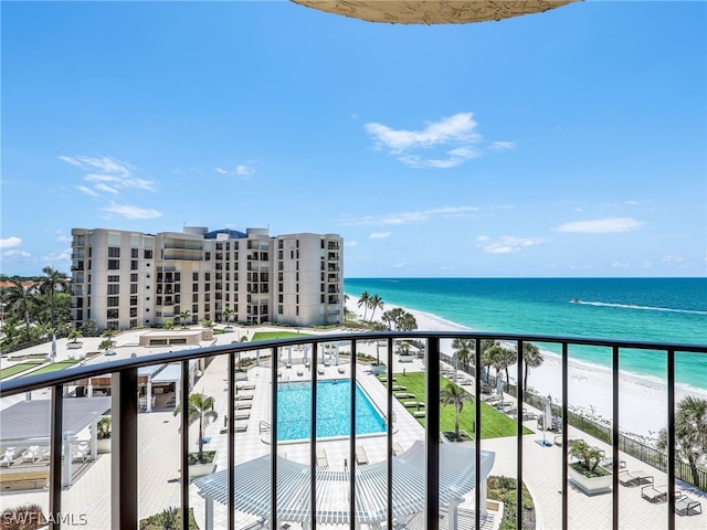 balcony featuring a water view and a view of the beach